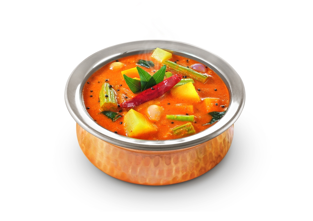 kadamba sambar on a copper cup with a white background